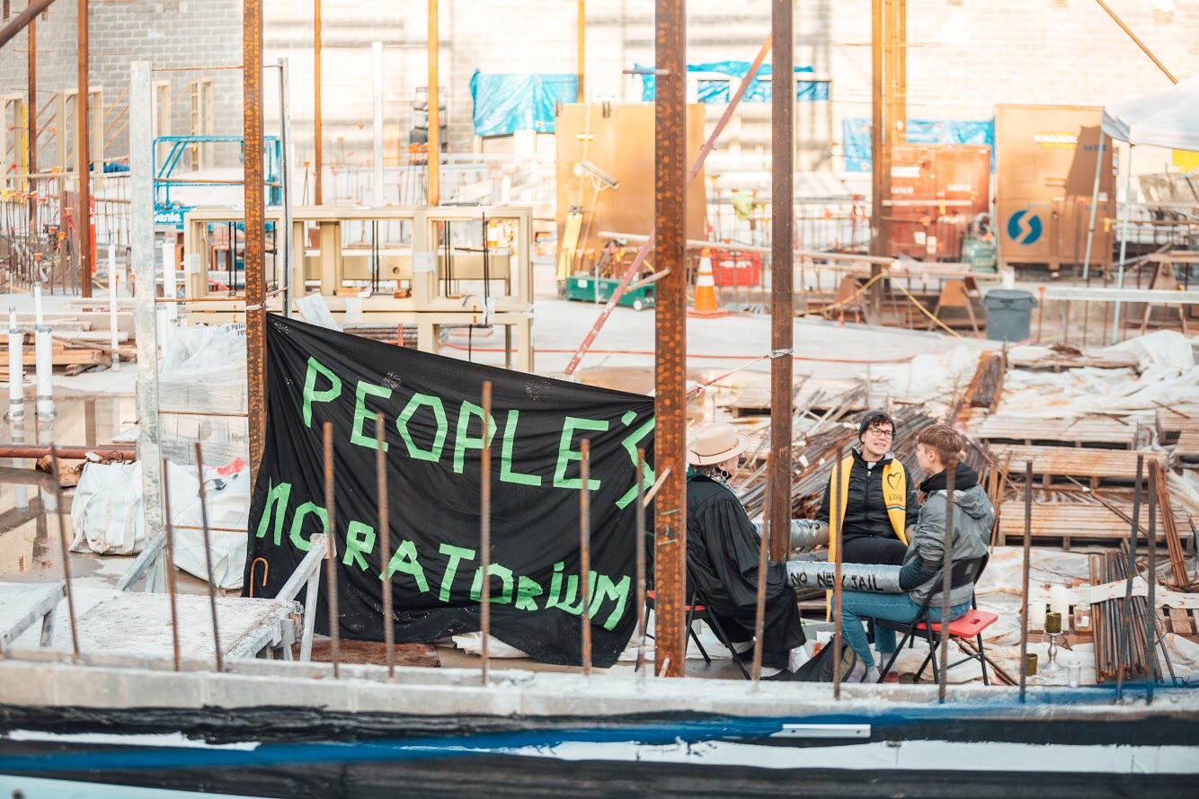 Clergy locked to beam inside the construction site of the new youth jail.