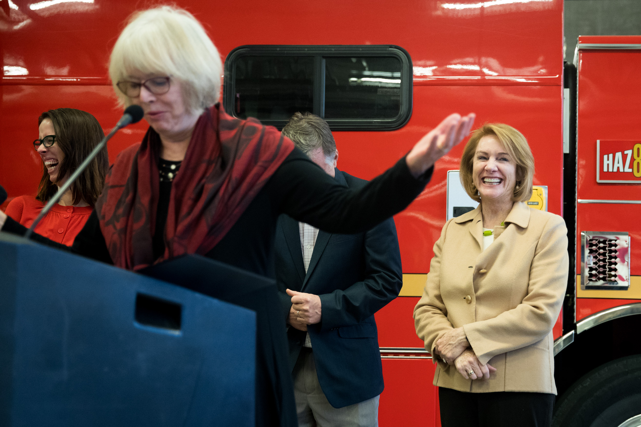 Mayor Jenny Durkan listens to Seattle City Councilmember Sally Bagshaw speak during a city budget signing ceremony at Fire Station 10 in Seattle, Nov. 26, 2018.