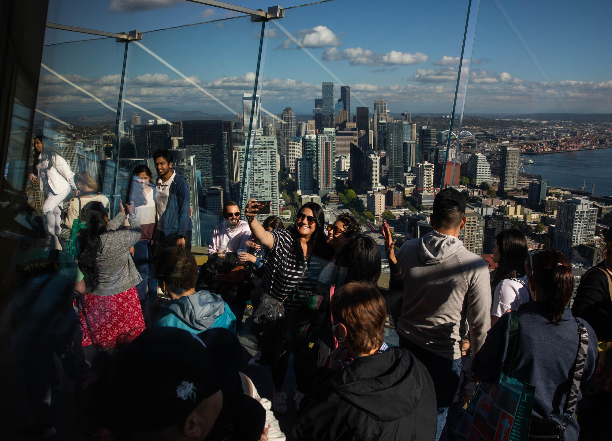 a group of people with the Seattle skyline behind them