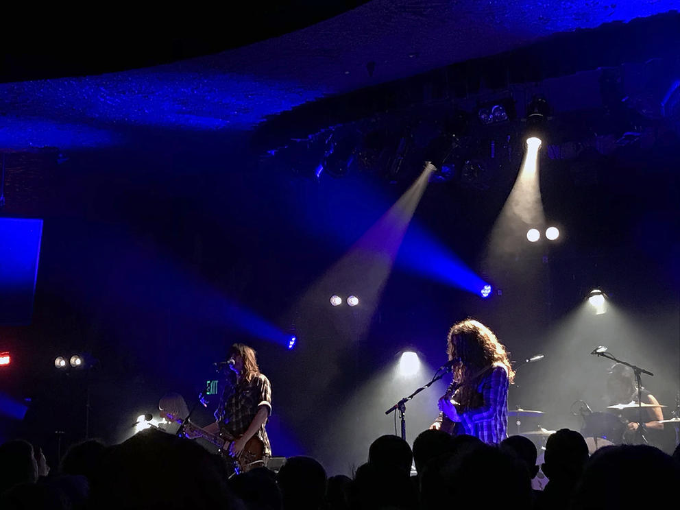 Two musicians perform onstage