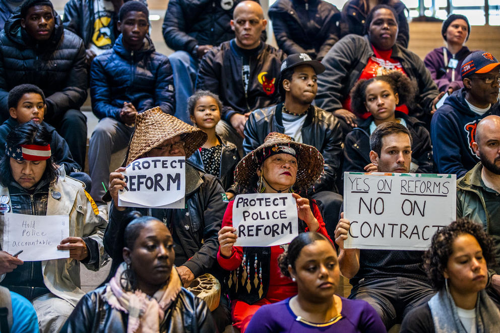 Protesters hold signs