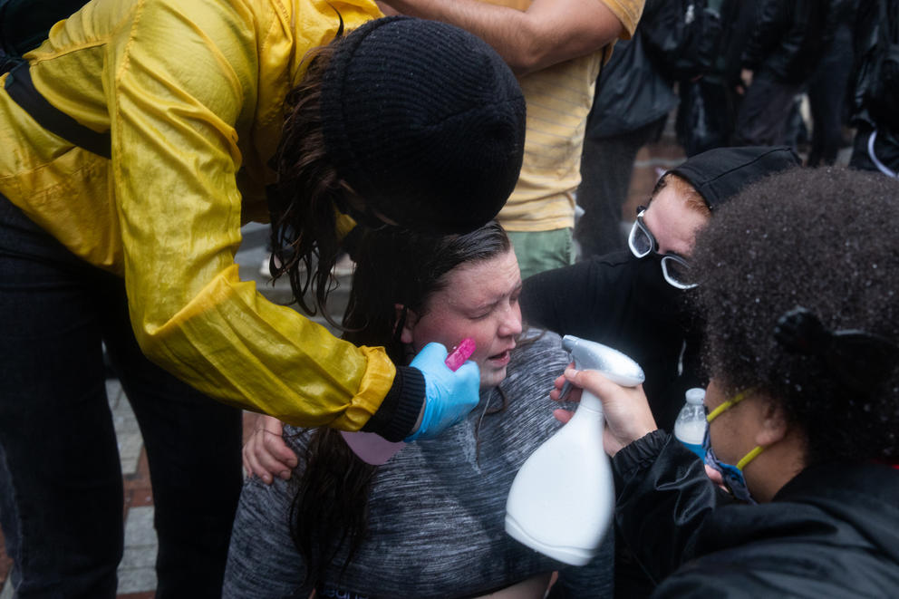 protesters wash their eyes out