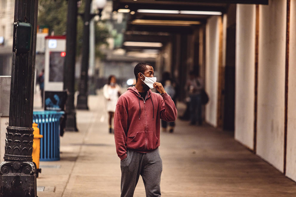 Masked pedestrians walk through Seattle's downtown in thick smoke haze.
