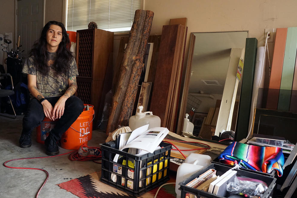 Person sitting in their basement with mirror