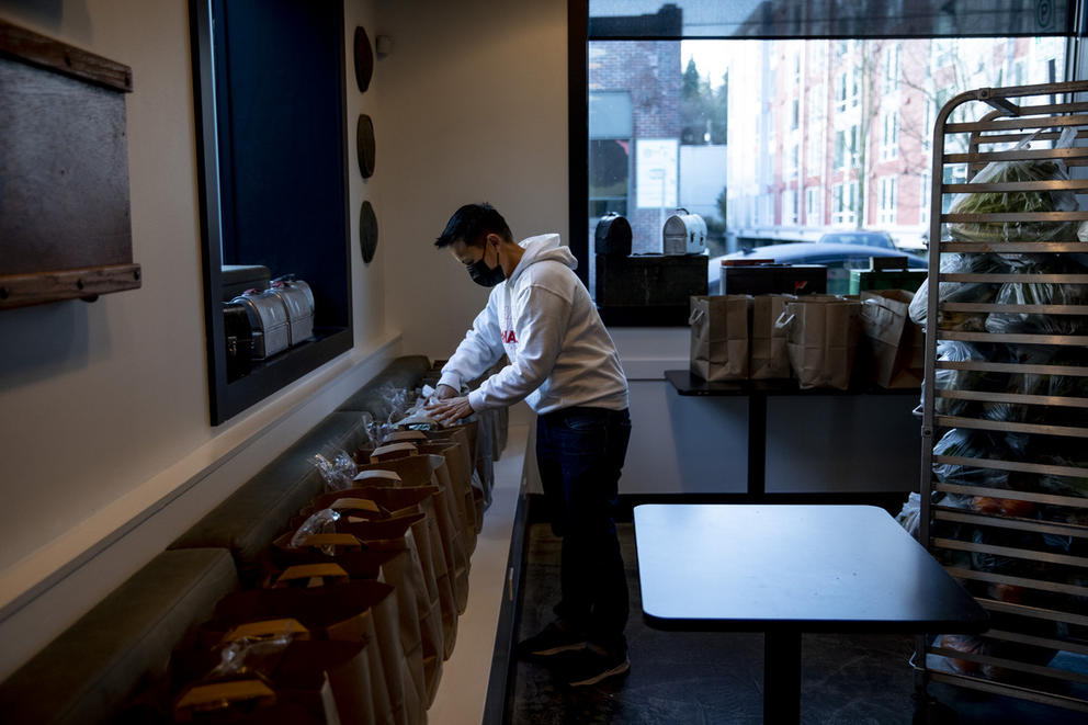 Roz Edison in empty restaurant, packing bags of food