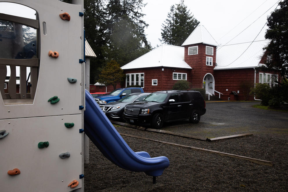 A playground is shown with a school in background