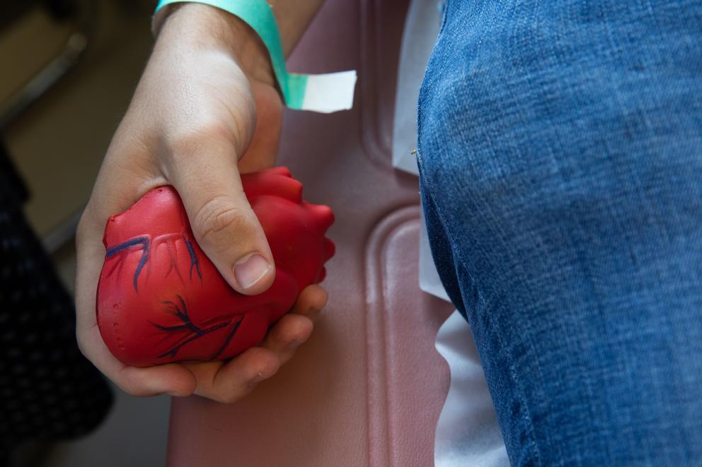 hand holding heart-shaped stress ball 