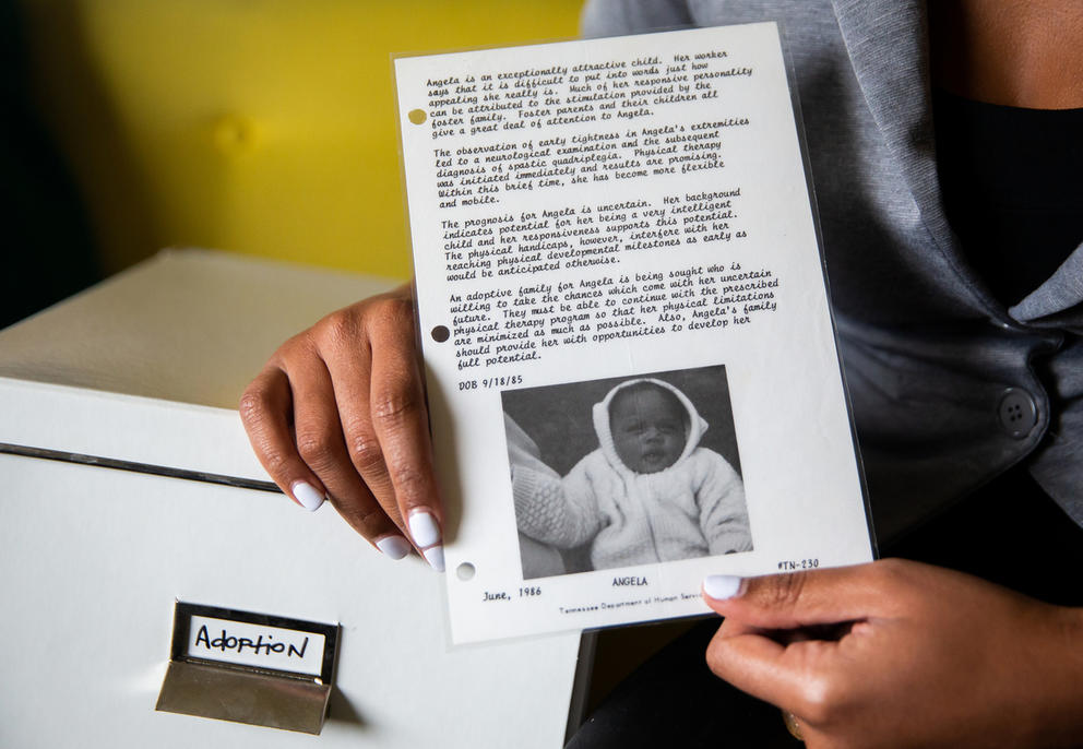 Angela Tucker holding adoption notice