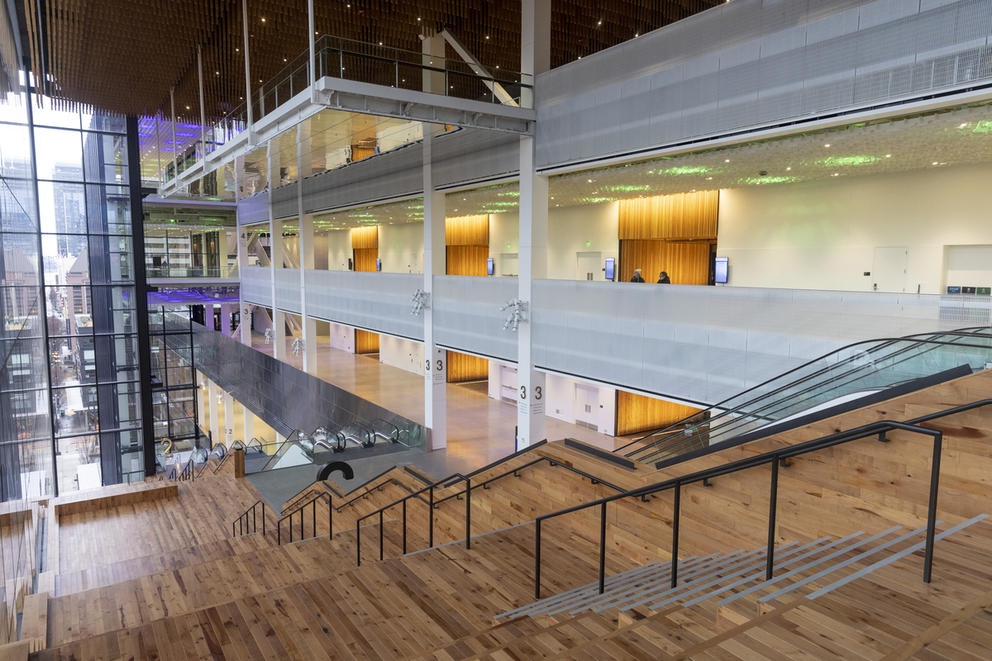 Wooden stairs and glass escalators are pictured from the fourth level of the new Seattle Convention Center Summit building.