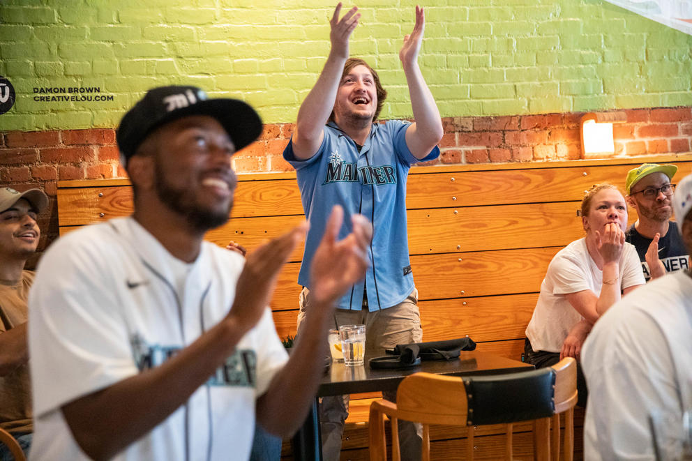 People clap in side a bar