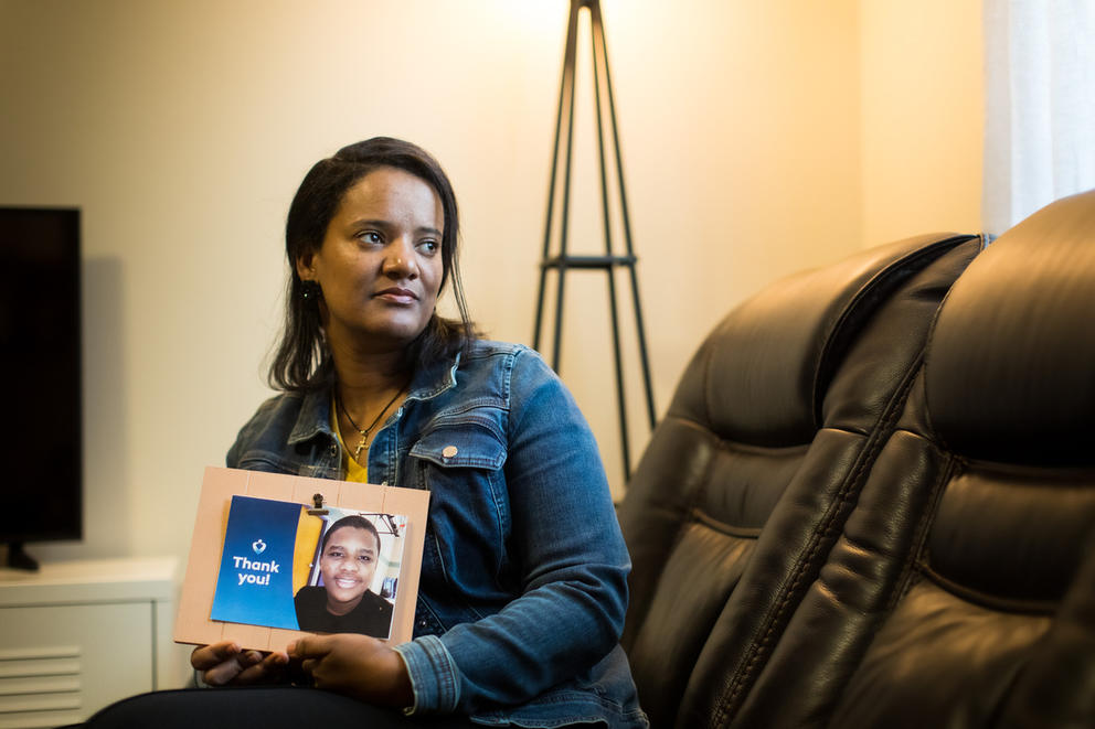 Mother holding photo of son