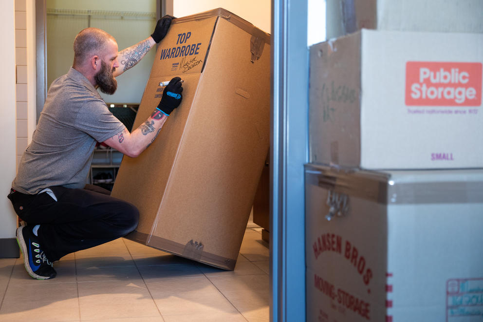 A man labels a cardboard box