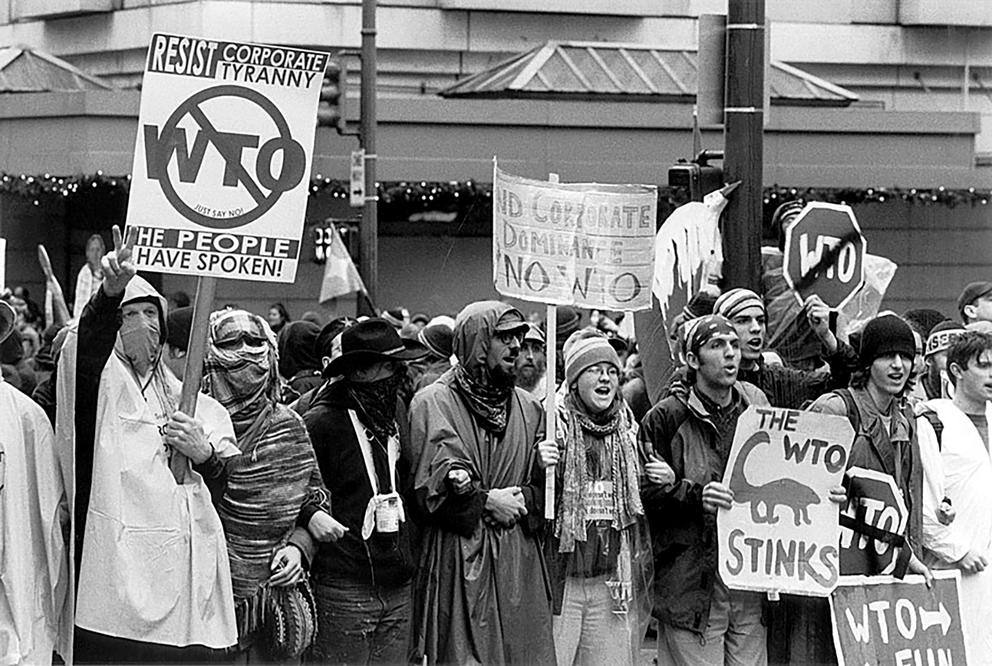 WTO protesters waving signs in 1999