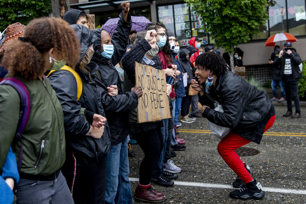 A protester in front of a line of marchers