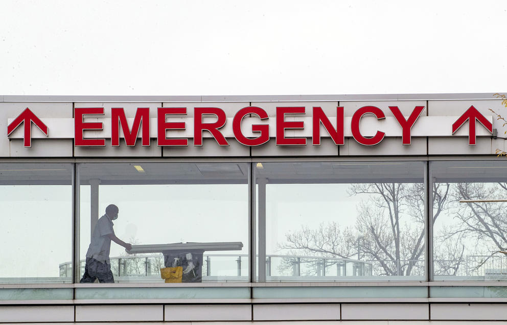 A building sign reads "EMERGENCY"