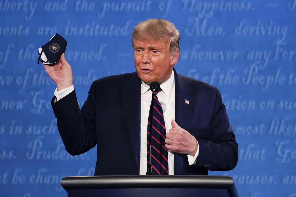 Trump holding a mask