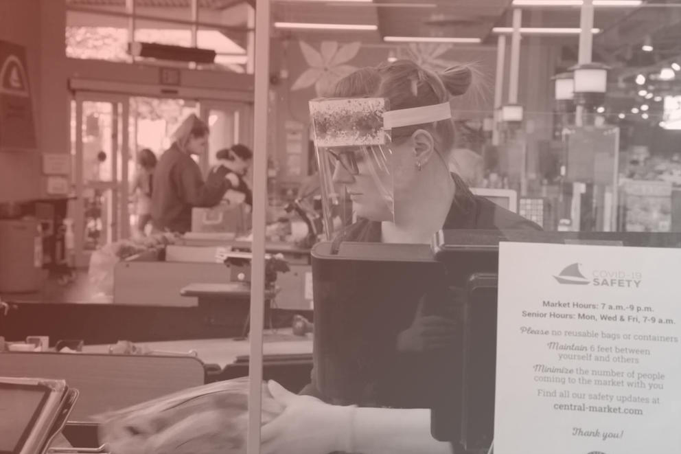 a grocery store manager with in a face shield
