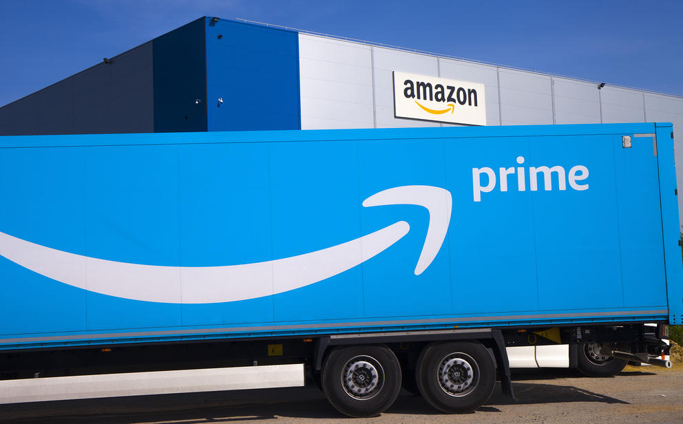 Amazon truck with logo in front of buiding