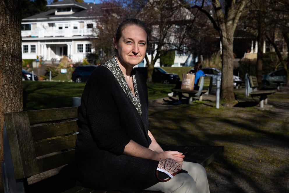 a person sits on a bench looking at the camera