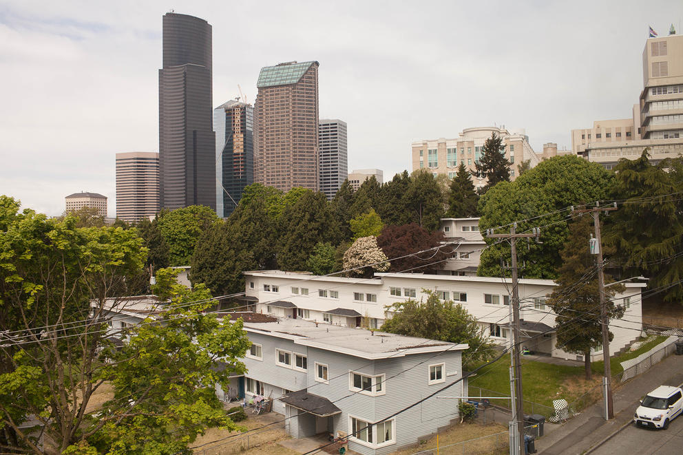 an apartment complex, with downtown towering behind it