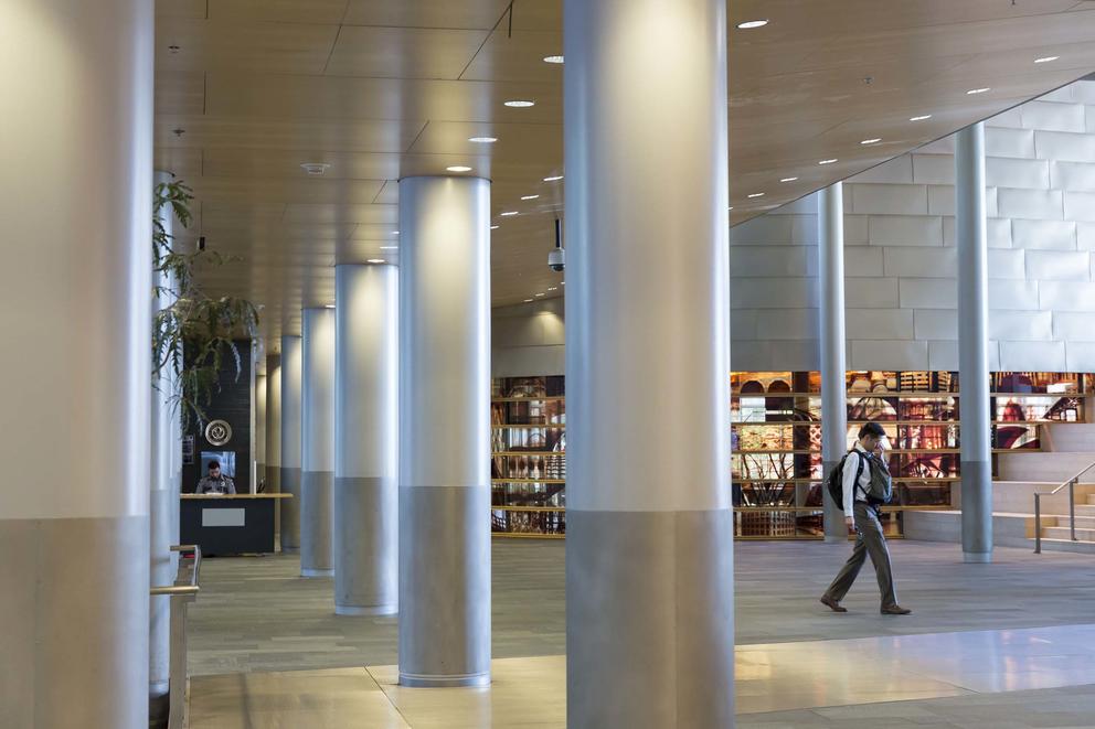 A man walking inside the main lobby of Seattle City Hall 