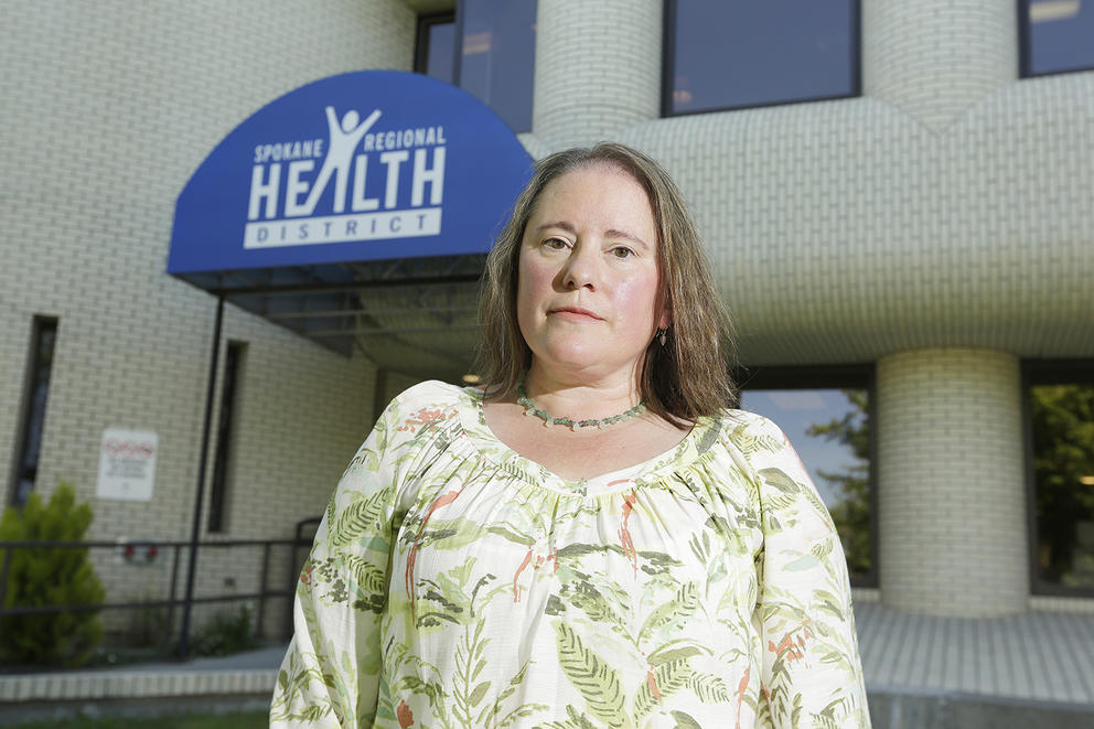 Woman stands in front of building