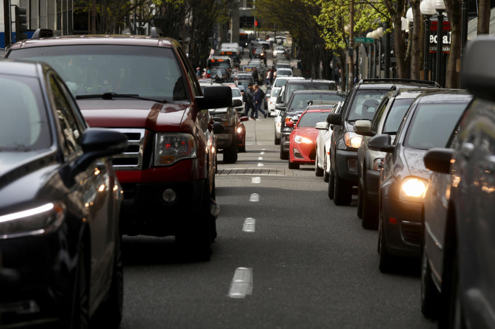 Rows of automobiles on either side of lane marker