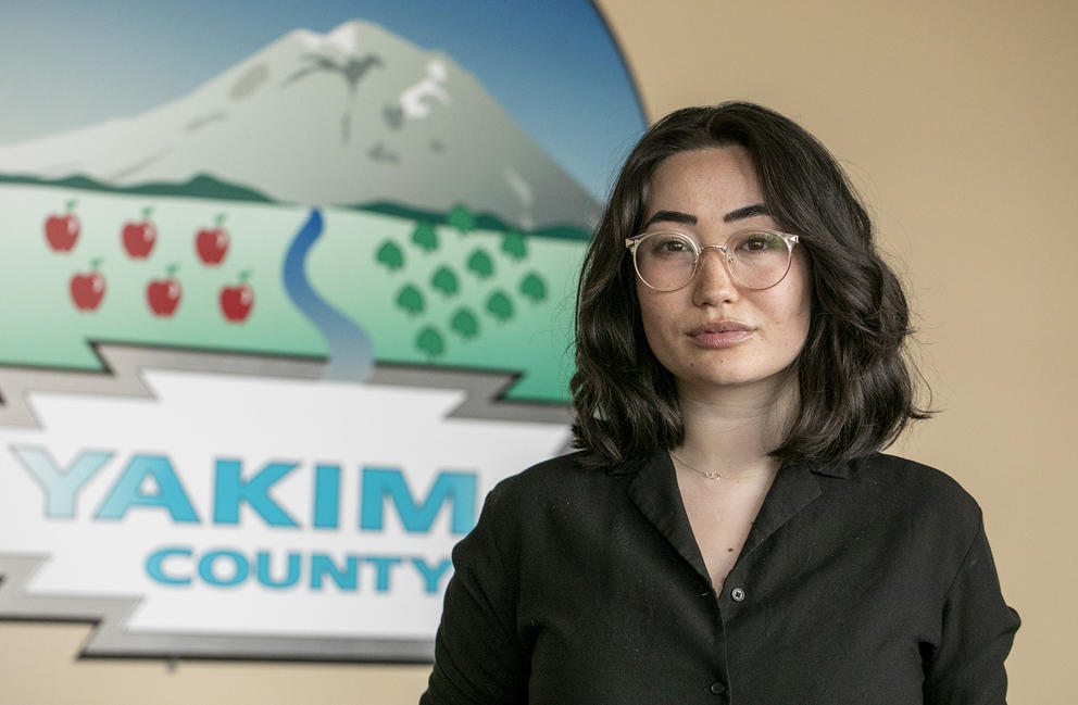 Yakima County's Human Services director stands in her office.