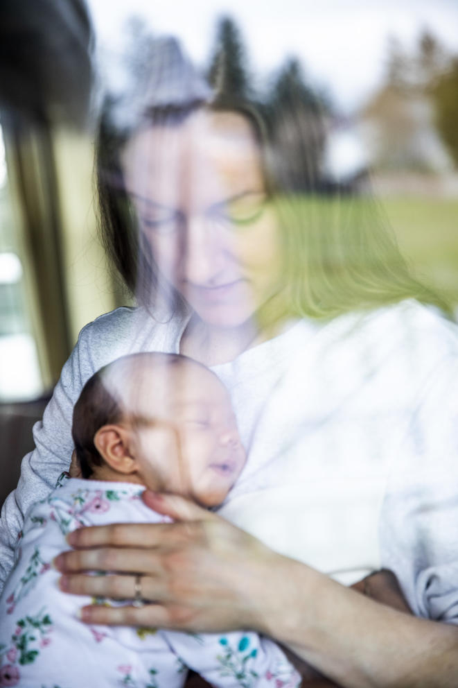 A mother holding her infant daughter