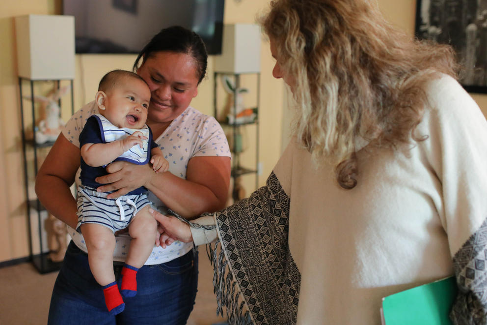 Outreach doula Margarita Celis, right, visits with one of her clients. 