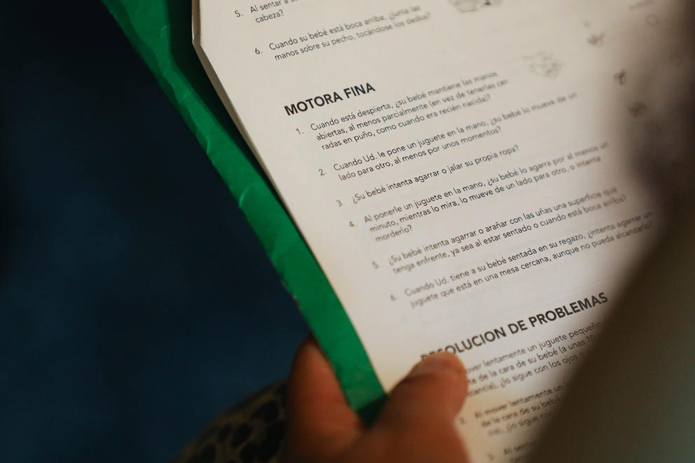 A doula goes over a questionnaire in Spanish with one of her clients.