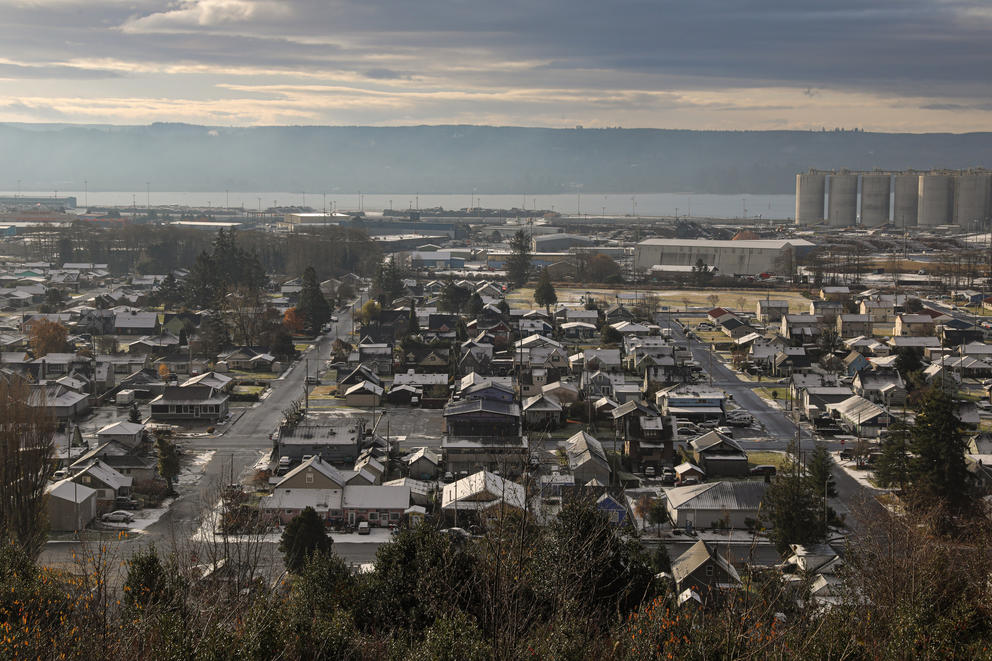 A view from above of a neighborhood, a river is in the background