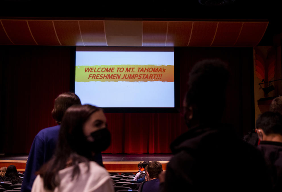 Students wearing masks in an auditorium