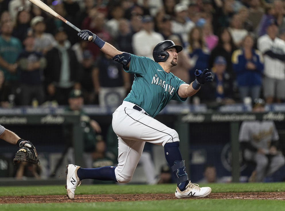 Man with a baseball bat completing a mighty swing