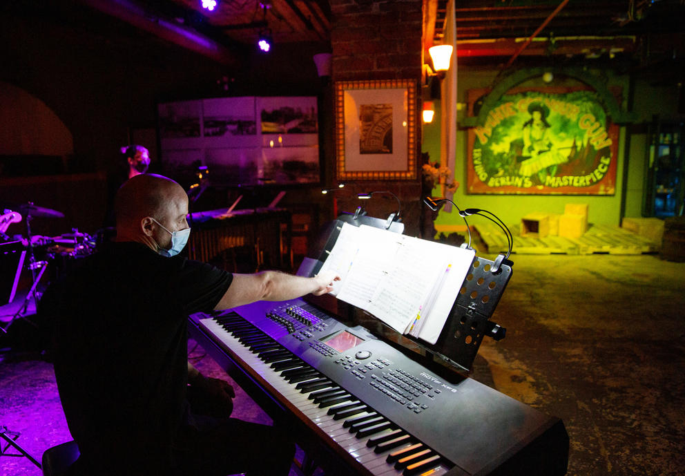 A man sits behind a piano