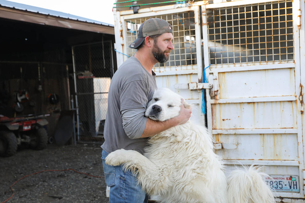 Bradley Newhall hugging a dog 