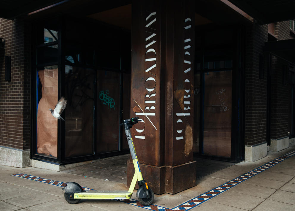 Brown paper and graffiti hangs in the windows of a former Starbucks storefront.