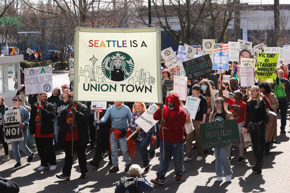 protesters hold signs
