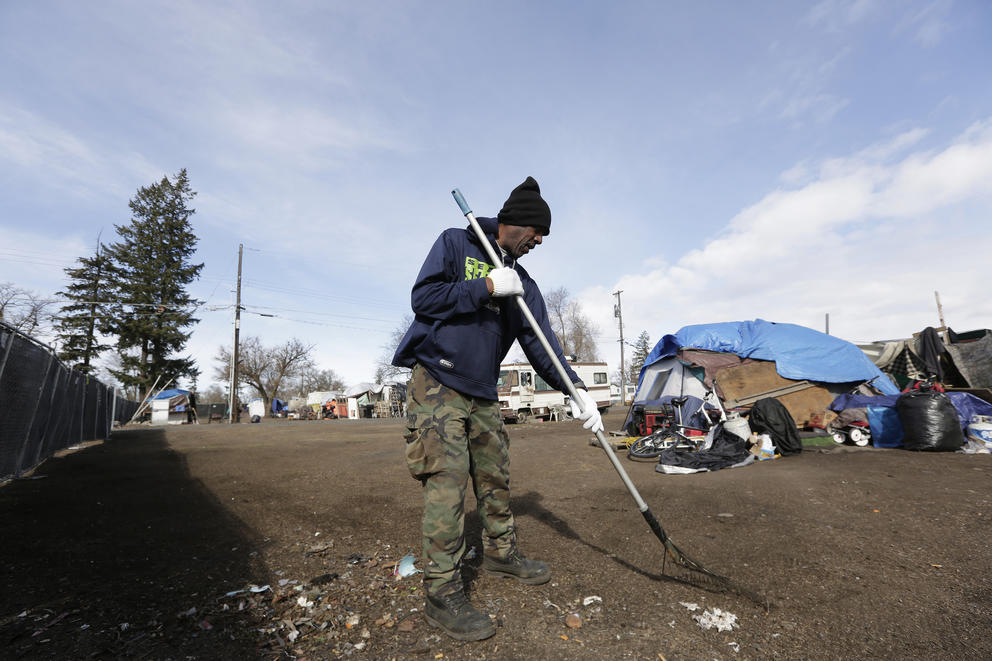employee and resident cleaning up at Camp Hope