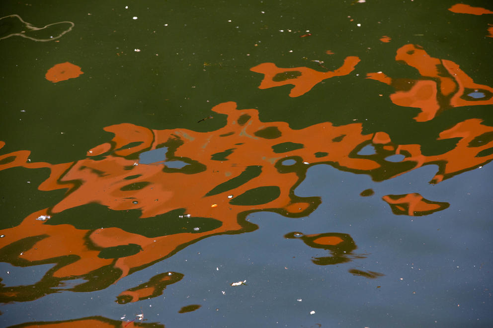 a reflection of a barge on the water 