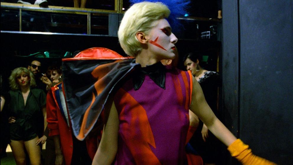 An actor in a brightly colored costume 