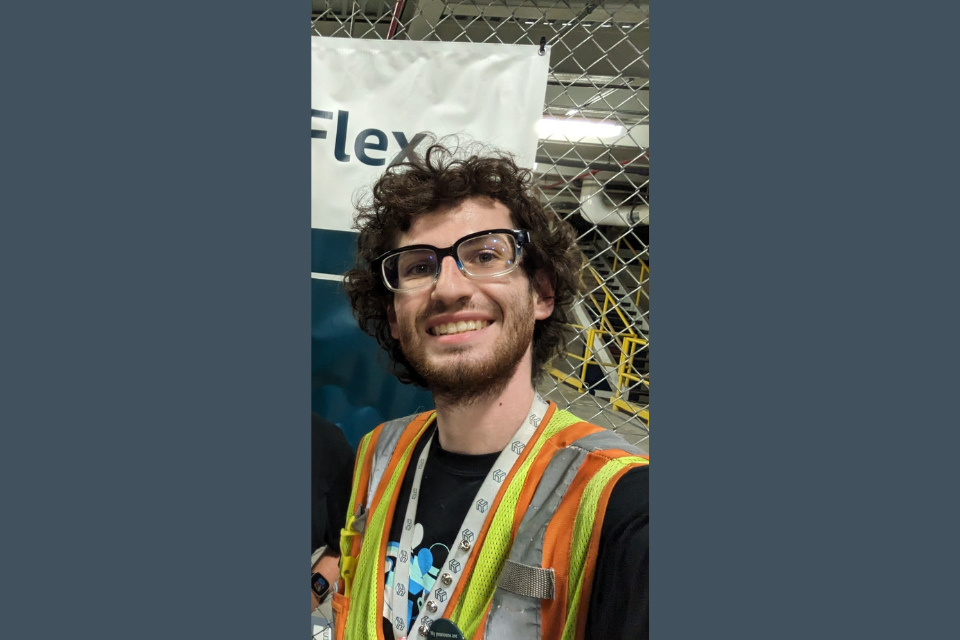 Jacob Misavage smiles behind safety glasses