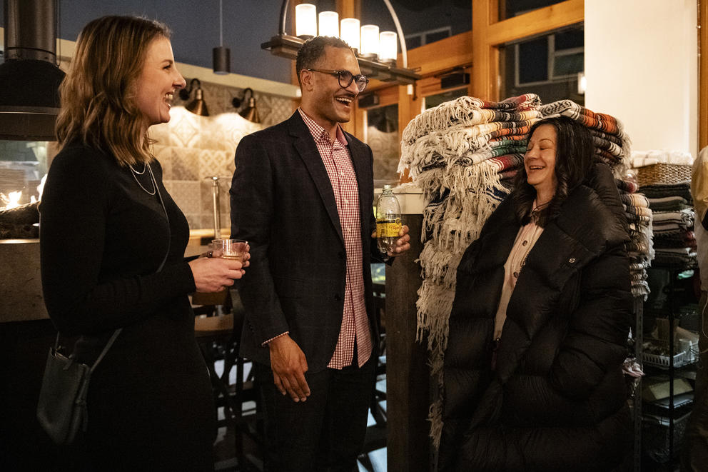 a man talks to two women at an election night party