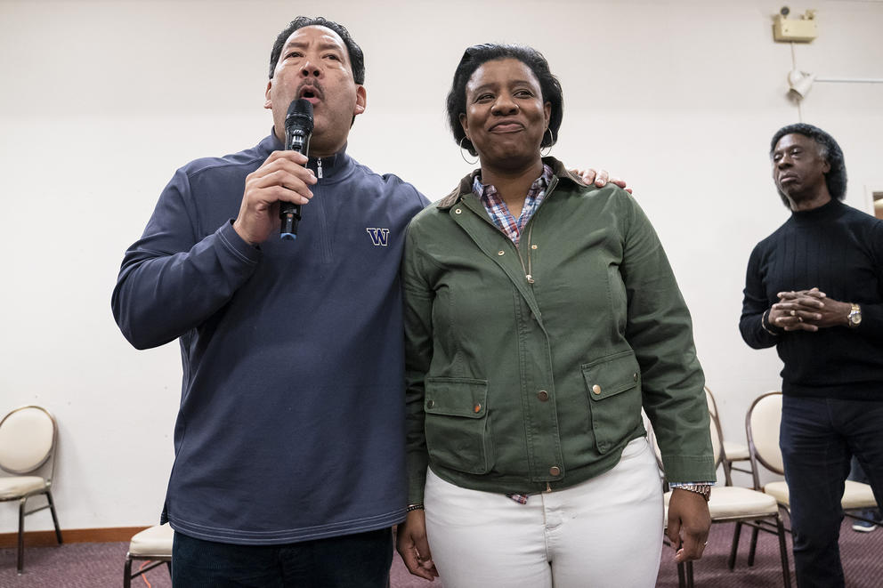 a man and woman stand together on a stage
