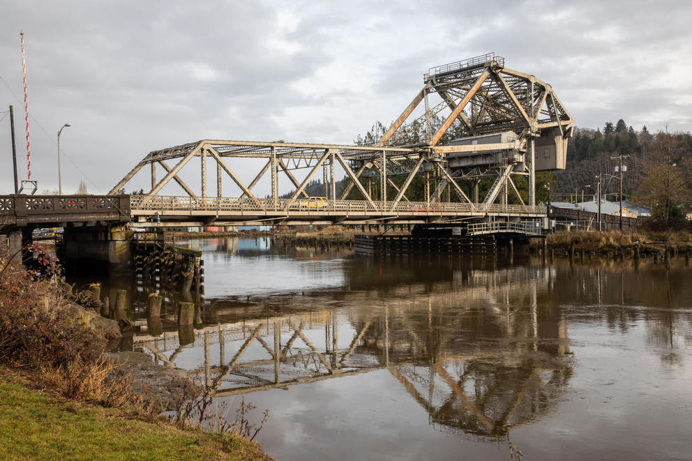 A bridge reflected in water.