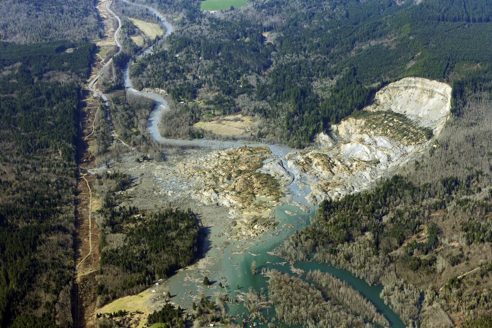 Aerial view of a massive mudslide that cut into a hillside and slid into a neighborhood.