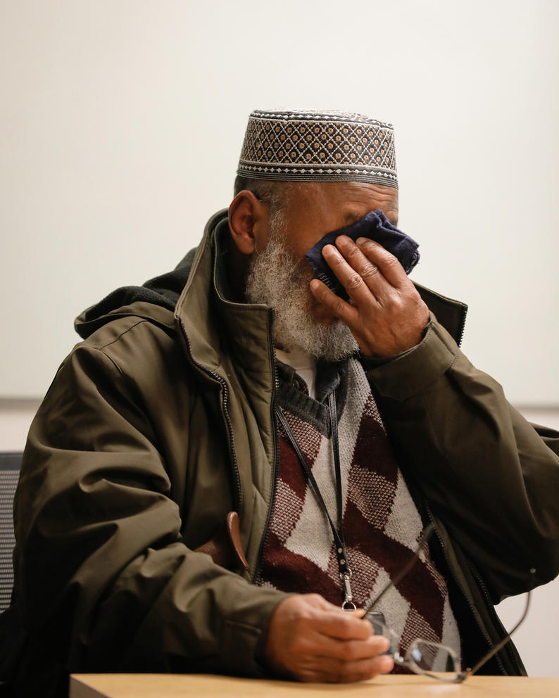 a man cries into his handkerchief 