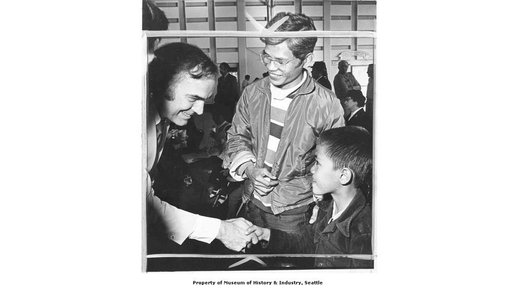 Governor Dan Evans greeting Tony Le and son