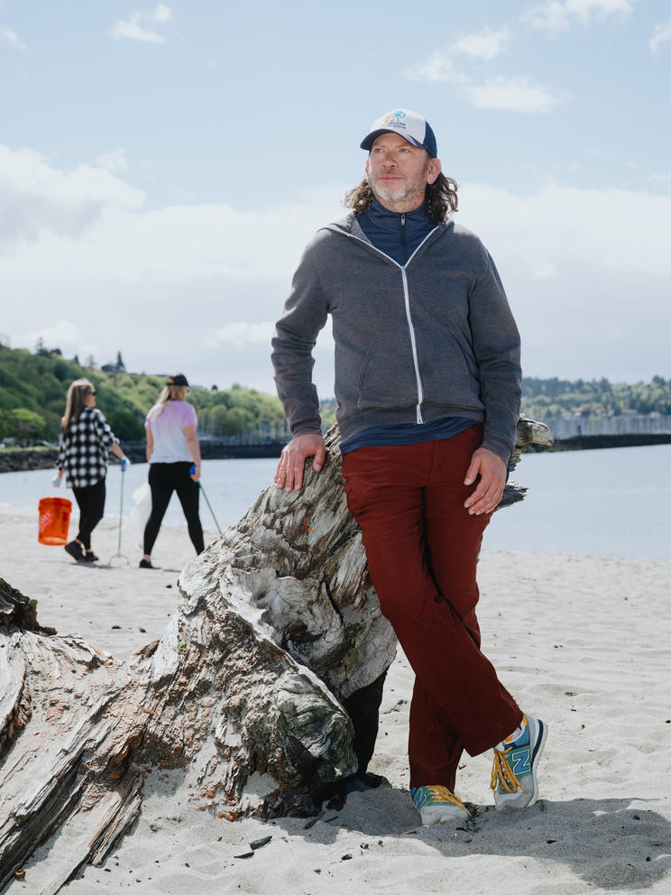 A portrait of Drew Albenze standing on the beach