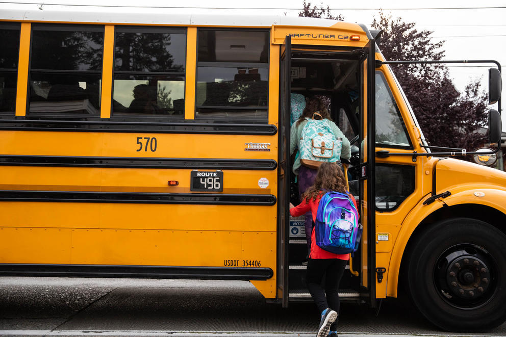 Students board the bus to Hamilton International Middle School